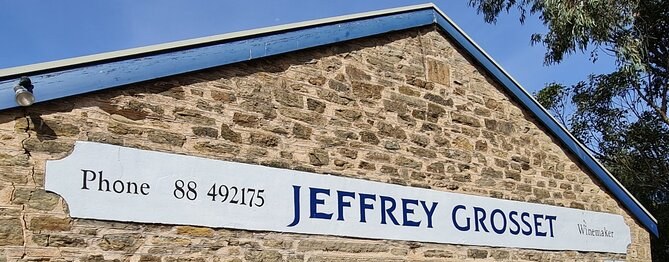 The stone cellar door of Jeffrey Grosset, winemaker, under its painted sign